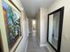 Light and bright hallway with wood-look floors, leading to bathroom and other rooms at 3187 Sea World Ct, Kissimmee, FL 34746