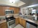 Kitchen with stainless steel appliances and wood cabinets at 3187 Sea World Ct, Kissimmee, FL 34746