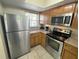 Kitchen with stainless steel appliances and wood cabinets at 3187 Sea World Ct, Kissimmee, FL 34746