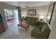 Comfortable living room with olive green sofa and access to a patio at 3187 Sea World Ct, Kissimmee, FL 34746