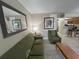 Spacious living room with olive green sofa and large mirror at 3187 Sea World Ct, Kissimmee, FL 34746