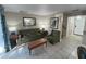 Living area featuring an olive green sofa and wood coffee table at 3187 Sea World Ct, Kissimmee, FL 34746
