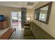 Living room with olive green sofa and sliding doors to patio at 3187 Sea World Ct, Kissimmee, FL 34746