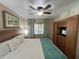 Spacious bedroom with king-size bed and built-in entertainment center at 3187 Sea World Ct, Kissimmee, FL 34746
