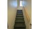 Carpeted staircase with wooden handrail at 3187 Sea World Ct, Kissimmee, FL 34746