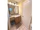 Bright bathroom featuring a granite vanity, updated lighting, and neutral flooring at 3197 Sea World Ct, Kissimmee, FL 34746