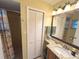 Bright bathroom featuring a granite vanity, updated lighting, and a shower with a beach-themed curtain at 3197 Sea World Ct, Kissimmee, FL 34746