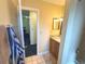 Bathroom with a light wood vanity and a tile floor at 3197 Sea World Ct, Kissimmee, FL 34746