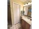 The bathroom has a single vanity with cabinet, large mirror, and enclosed shower with glass door at 3197 Sea World Ct, Kissimmee, FL 34746