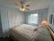 Bright and airy bedroom with a ceiling fan, comfortable bed, and neutral decor at 3197 Sea World Ct, Kissimmee, FL 34746