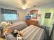 Bedroom with two twin beds, ceiling fan, closet, dresser with TV and natural light at 3197 Sea World Ct, Kissimmee, FL 34746