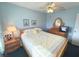 Cozy bedroom with a ceiling fan, comfortable bed, and charming decor at 3197 Sea World Ct, Kissimmee, FL 34746