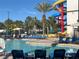 Resort-style community pool with blue lounge chairs and tall waterslide in the background at 3197 Sea World Ct, Kissimmee, FL 34746