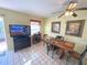 The dining room offers a table with seating for four, a ceiling fan, and adjacent media center with TV at 3197 Sea World Ct, Kissimmee, FL 34746