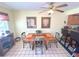 The dining room offers a square table with seating for four, a ceiling fan, and adjacent kitchen bar at 3197 Sea World Ct, Kissimmee, FL 34746
