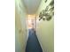 Inviting hallway featuring decorative fish art and leading to a bathroom with ladder at 3197 Sea World Ct, Kissimmee, FL 34746