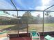 Screened in lanai offering views of the yard, playground, and surrounding trees at 3197 Sea World Ct, Kissimmee, FL 34746