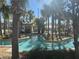 Community lazy river featuring tiled edging and palm tree landscaping at 3197 Sea World Ct, Kissimmee, FL 34746