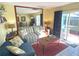 Comfortable living room with a large mirror and sliding glass doors to an outdoor patio at 3197 Sea World Ct, Kissimmee, FL 34746