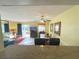 View of the living room, dining area, and sliding glass doors leading to an outdoor patio at 3197 Sea World Ct, Kissimmee, FL 34746
