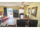 Open-concept living room with dining area and sliding glass doors to a screened patio at 3197 Sea World Ct, Kissimmee, FL 34746