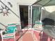 Relaxing patio featuring a sliding glass door, stylish seating, and a charming sun decoration at 3197 Sea World Ct, Kissimmee, FL 34746