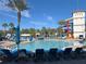 Inviting resort pool with multiple lounge chairs and waterslide at 3197 Sea World Ct, Kissimmee, FL 34746