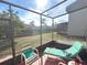 Enclosed patio area with furniture and a view of the community playground and landscaping at 3197 Sea World Ct, Kissimmee, FL 34746