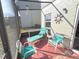 Enclosed back porch area featuring a lounger, cushioned chairs, and access to backyard at 3197 Sea World Ct, Kissimmee, FL 34746