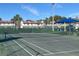 Well-maintained tennis court surrounded by lush landscaping and neighborhood townhomes at 3197 Sea World Ct, Kissimmee, FL 34746