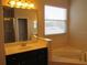 Bathroom with soaking tub, vanity, and separate shower at 3260 Sorrel Ct, Deltona, FL 32725