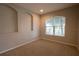 Simple bedroom with neutral wall and carpet colors, and a large window at 3260 Sorrel Ct, Deltona, FL 32725