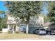 Two-story house with a green facade, stone accents, and a two-car garage at 3260 Sorrel Ct, Deltona, FL 32725
