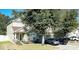 Two-story house with a green facade, stone accents, and a two-car garage at 3260 Sorrel Ct, Deltona, FL 32725