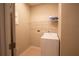 Well-lit laundry room with washer, dryer, and shelving at 3260 Sorrel Ct, Deltona, FL 32725