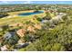 Aerial view of houses near a golf course and lake at 4 Arika At Lionspaw, Daytona Beach, FL 32124