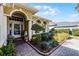 Front entry with a walkway, lush landscaping and columns at 4 Arika At Lionspaw, Daytona Beach, FL 32124