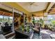 Covered lanai with wicker furniture and view of the backyard at 4 Arika At Lionspaw, Daytona Beach, FL 32124