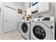 Convenient laundry room with washer, dryer, and cabinets at 4 Arika At Lionspaw, Daytona Beach, FL 32124