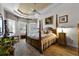 Large main bedroom with wood post bed and window seating at 4 Arika At Lionspaw, Daytona Beach, FL 32124