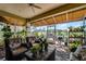 Relaxing sunroom with wicker furniture and scenic golf course view at 4 Arika At Lionspaw, Daytona Beach, FL 32124