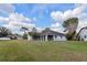 Wide backyard with a grey house, a screen windows, and a metal fence at 4001 Misty Morning Pl, Casselberry, FL 32707