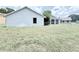 A partial view of the fenced backyard, exterior wall and window at 4001 Misty Morning Pl, Casselberry, FL 32707