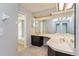 Bright bathroom with double sinks, vanity lighting, and a separate toilet and shower area at 4001 Misty Morning Pl, Casselberry, FL 32707