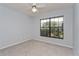 Comfortable bedroom with neutral carpet, a ceiling fan, and a large window, providing a cozy retreat at 4001 Misty Morning Pl, Casselberry, FL 32707