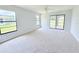 Bright bedroom featuring neutral carpet, ceiling fan and slider to outdoor patio at 4001 Misty Morning Pl, Casselberry, FL 32707