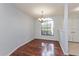 Cozy dining room featuring hardwood floors, a chandelier, and a large window for plenty of natural light at 4001 Misty Morning Pl, Casselberry, FL 32707