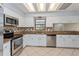 Well-maintained kitchen with stainless steel appliances, tile backsplash, and ample cabinet space at 4001 Misty Morning Pl, Casselberry, FL 32707
