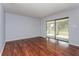 Spacious living room showcasing sleek wood flooring and sliding glass doors to the outdoor patio at 4001 Misty Morning Pl, Casselberry, FL 32707