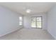 Large bedroom with neutral carpet, ceiling fan, and sliding door to the lanai, perfect for relaxation at 4001 Misty Morning Pl, Casselberry, FL 32707